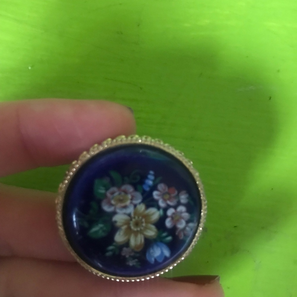 Vintage floral print against royal blue clasp pin